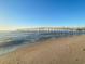 Picturesque view of a long pier stretching over the ocean from a sandy beach at 1501 S Ocean Blvd. # 1009, Myrtle Beach, SC 29577