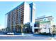 Beautiful exterior of the Landmark Resort with palm trees and a blue sky at 1501 S Ocean Blvd. # 1009, Myrtle Beach, SC 29577