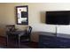A flat screen TV and drawers near the kitchenette and a small table at 1501 S Ocean Blvd. # 1009, Myrtle Beach, SC 29577