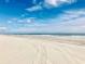 Expansive beach with white sand and clear blue sky, showing tire tracks at 1501 S Ocean Blvd. # 1107, Myrtle Beach, SC 29577