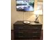 Bedroom featuring a dresser, TV, tray, and modern lamp, creating a cozy and functional space at 1501 S Ocean Blvd. # 1107, Myrtle Beach, SC 29577