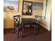 Cozy dining area with a small table, two chairs, and nautical-themed wall decor at 1501 S Ocean Blvd. # 1107, Myrtle Beach, SC 29577