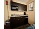 Kitchenette featuring dark cabinets, countertop space, sink, microwave, and mini-fridge at 1501 S Ocean Blvd. # 1107, Myrtle Beach, SC 29577