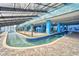 Indoor lazy river with tropical landscaping, blue accents, and a relaxing atmosphere at 1501 S Ocean Blvd. # 1107, Myrtle Beach, SC 29577