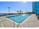 Outdoor pool area with lounge chairs and an ocean view in a sunny day at 1501 S Ocean Blvd. # 1107, Myrtle Beach, SC 29577