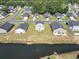 Quiet community is bordered by a pond and features sidewalks, mature trees, and landscaping at 153 Foxford Dr., Conway, SC 29526