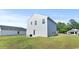 Exterior back view features a well-maintained lawn, patio area, and gray siding at 153 Foxford Dr., Conway, SC 29526