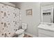 Well-lit bathroom featuring a decorative shower curtain, toilet, and vanity with mirror at 153 Foxford Dr., Conway, SC 29526