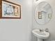 Minimalist bathroom featuring a pedestal sink, round mirror, and simple, clean design at 153 Foxford Dr., Conway, SC 29526