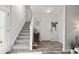 Welcoming entryway with stairs, neutral tones, and wood-look floors leads to the upper level at 153 Foxford Dr., Conway, SC 29526