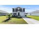 Charming two-story home boasts manicured lawn, attached garage, and classic architectural details at 153 Foxford Dr., Conway, SC 29526