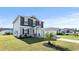 Charming two-story home featuring a manicured lawn, complemented by a young palm tree at 153 Foxford Dr., Conway, SC 29526