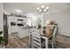 Bright kitchen and dining area featuring white cabinets, an island, and wood-look flooring at 153 Foxford Dr., Conway, SC 29526