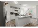 Well-lit kitchen boasting white cabinets, an island with marble countertops, and modern appliances at 153 Foxford Dr., Conway, SC 29526