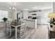 Open concept kitchen and dining area with a breakfast bar, white cabinets and stainless-steel refrigerator at 153 Foxford Dr., Conway, SC 29526
