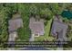 Stunning aerial view of home showcasing well-maintained landscaping, lush greenery, and a whole house generator at 156 Summerlight Dr., Murrells Inlet, SC 29576