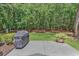 Spacious backyard patio with a grill and view of the wooded area at 156 Summerlight Dr., Murrells Inlet, SC 29576