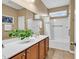 Bright bathroom featuring double sinks, white shower/tub, and tile flooring at 156 Summerlight Dr., Murrells Inlet, SC 29576