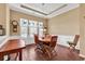 Inviting dining room with tray ceiling, wainscoting, and large windows creating a warm ambiance at 156 Summerlight Dr., Murrells Inlet, SC 29576