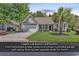 Charming single-story home with a well-manicured lawn, mature trees, and an attached two-car garage at 156 Summerlight Dr., Murrells Inlet, SC 29576
