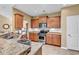 Well-lit kitchen featuring stainless steel appliances, granite countertops, and honey colored wood cabinetry at 156 Summerlight Dr., Murrells Inlet, SC 29576