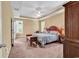 Comfortable main bedroom featuring tray ceiling, ceiling fan, and ample natural light from large windows at 156 Summerlight Dr., Murrells Inlet, SC 29576
