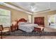 Spacious main bedroom featuring tray ceiling, ceiling fan, and ample natural light from large windows at 156 Summerlight Dr., Murrells Inlet, SC 29576