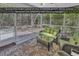 Relaxing screened porch with comfortable wicker furniture and serene views of the low country foliage at 156 Summerlight Dr., Murrells Inlet, SC 29576
