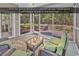 Inviting screened porch with stylish seating and views of the serene backyard with mature trees at 156 Summerlight Dr., Murrells Inlet, SC 29576