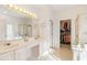 Bright bathroom featuring double vanity, walk-in shower, and a walk-in closet at 1617 Tradition Club Dr., Pawleys Island, SC 29585