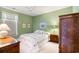 Charming bedroom with floral accents, comfortable bed, and ample natural light at 1617 Tradition Club Dr., Pawleys Island, SC 29585