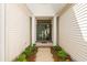 Inviting entryway featuring double doors, classic columns, and lush landscaping at 1617 Tradition Club Dr., Pawleys Island, SC 29585