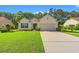 Charming single-story home with a well-manicured lawn, attached garage, and inviting curb appeal at 1617 Tradition Club Dr., Pawleys Island, SC 29585