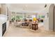 Sun-filled living room featuring a fireplace, large windows, and neutral decor at 1617 Tradition Club Dr., Pawleys Island, SC 29585