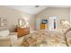 Spacious main bedroom features an ensuite, a lounge chair, and neutral decor at 1617 Tradition Club Dr., Pawleys Island, SC 29585