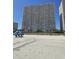 Large beachfront condo building with many balconies, ocean view, and tire tracks in the sand at 1625 S Ocean Blvd. # 106, North Myrtle Beach, SC 29582