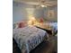 Cozy bedroom featuring two beds with patterned bedding and a flamingo art piece at 1625 S Ocean Blvd. # 106, North Myrtle Beach, SC 29582