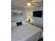 Comfortable bedroom with soft bedding, TV, and scenic beach-themed decor at 1625 S Ocean Blvd. # 106, North Myrtle Beach, SC 29582