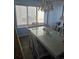 Bright dining area with stylish table, chairs, chandelier, with a large window and ocean view at 1625 S Ocean Blvd. # 106, North Myrtle Beach, SC 29582