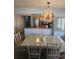 Elegant dining area with chandelier next to kitchen with stainless steel appliances, creating an inviting atmosphere at 1625 S Ocean Blvd. # 106, North Myrtle Beach, SC 29582