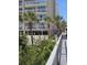 Condo complex with multiple balconies and lush landscaping, including palm trees, and a beach access path at 1625 S Ocean Blvd. # 106, North Myrtle Beach, SC 29582