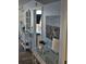 Hallway with decorative console table and coastal artwork leading to the living area and balcony at 1625 S Ocean Blvd. # 106, North Myrtle Beach, SC 29582