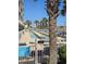 Clean pool area with palm trees and adjacent building at 1625 S Ocean Blvd. # 106, North Myrtle Beach, SC 29582