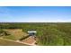 Aerial shot featuring the home's address and surrounding landscape with dense tree cover at 1676 Elder Ln., Galivants Ferry, SC 29544