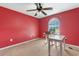Bedroom with red walls, carpet flooring, and a ceiling fan at 1676 Elder Ln., Galivants Ferry, SC 29544