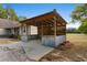 Rustic carport with wooden beams and metal accents, providing sheltered parking and outdoor storage at 1676 Elder Ln., Galivants Ferry, SC 29544