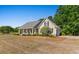 Well-maintained home with a covered porch, lush landscaping, and a side-entry garage on a spacious lot at 1676 Elder Ln., Galivants Ferry, SC 29544