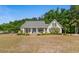 Charming home featuring a covered porch, manicured lawn, and tasteful landscaping, creating an inviting curb appeal at 1676 Elder Ln., Galivants Ferry, SC 29544