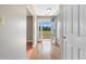 Bright foyer featuring gleaming wood floors and an open doorway to a spacious front yard at 1676 Elder Ln., Galivants Ferry, SC 29544