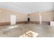 Clean and spacious garage featuring white doors, brick accent, and ample room for vehicles and storage at 1676 Elder Ln., Galivants Ferry, SC 29544